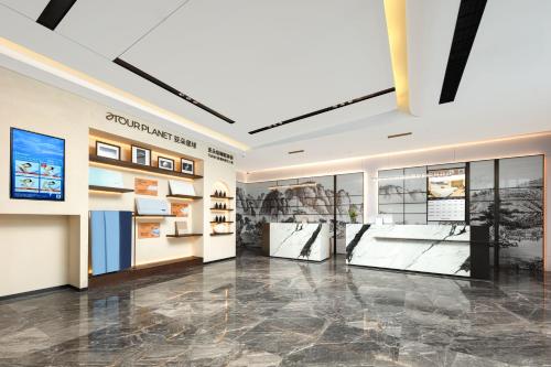 a large room with photographs on the walls and a lobby at Atour X Hotel Chengdu Jinhua Wanda Zhonggang Plaza in Chengdu