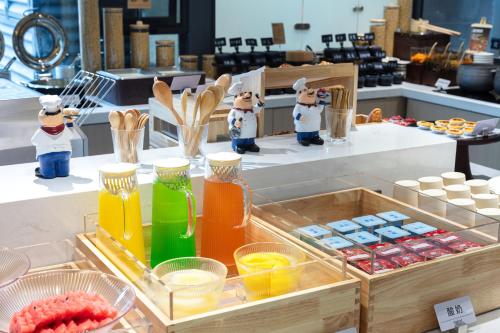 a table with containers of different colored liquids at Atour X Hotel Chengdu Jinhua Wanda Zhonggang Plaza in Chengdu