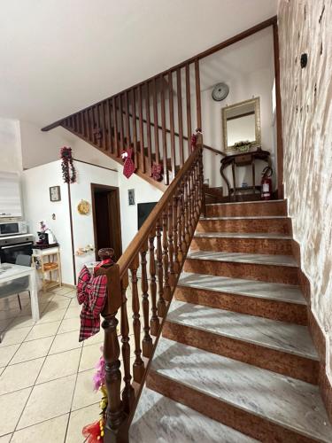 a wooden staircase in a living room with a stair case at Da Raffaella affittacamere in Cicciano