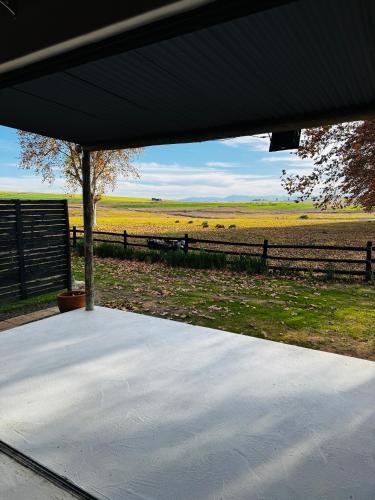 a view of a farm with a fence and a field at Rosetta Fields Country Lodge in Rosetta