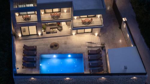 an overhead view of a building with a swimming pool at Artemis Villa in Lithakia