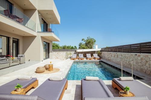 an image of a house with a swimming pool at Artemis Villa in Lithakia
