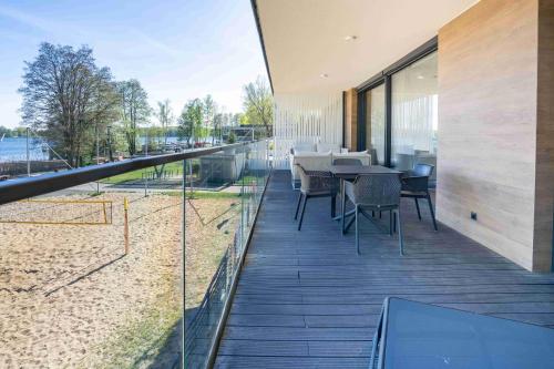 a balcony of a house with tables and chairs at Olimpijska Premium Elite4Rent in Olsztyn