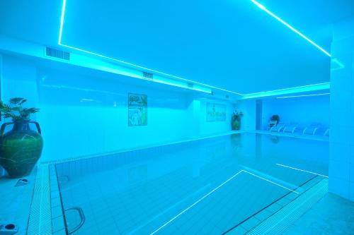 a swimming pool with a blue light on it at Av Club Terme Colella in Ischia