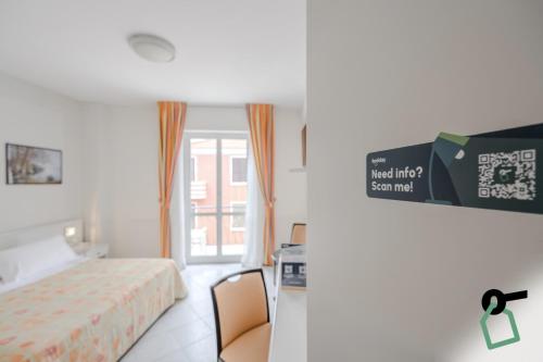 a hotel room with a bed and a window at HOTIDAY Room Collection - Alassio Centro in Alassio