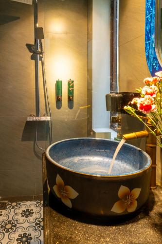 a bath tub with a faucet in a bathroom at Color House Sa Pa - Free BBQ in Sapa