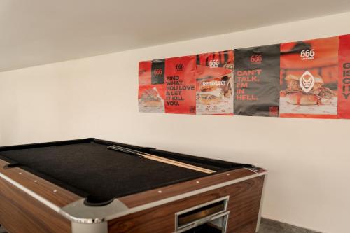 a pool table in a room with posters on the wall at Ryans Ibiza Apartments - Only Adults in Ibiza Town