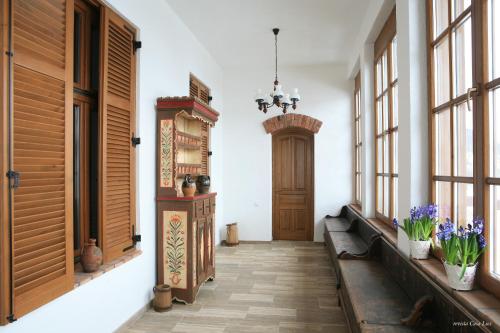 a hallway with a wooden door and some windows at Casa Kraus in Criţ