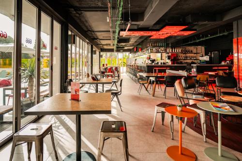 a room with tables and chairs in a restaurant at Ryans Ibiza Apartments - Only Adults in Ibiza Town