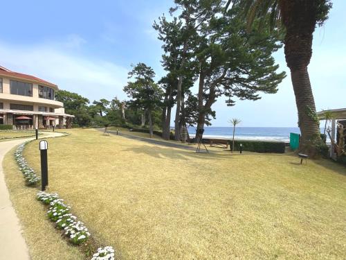 a park next to the ocean with flowers at Tokyu Vacations Izuimaihama in Kawazu