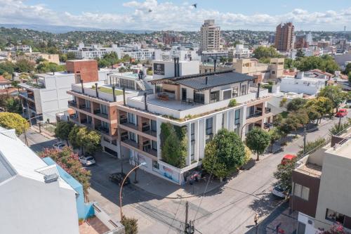 an aerial view of a building on a city street at Depto "Ideal" Céntrico, Pile Climat y Pile en Terraza, Cochera, Calef Central in Villa Carlos Paz