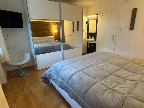 a bedroom with a large bed and a bathroom at Komfortables Ferienhaus In Landeck Mit Pool in Landeck