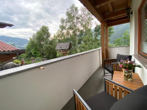 a balcony with a table and chairs and a view at Chalet Mühlbachl In Rohrberg Rohr in Zell am Ziller