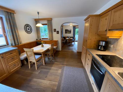 a kitchen with a table and a dining room at Chalet Mühlbachl In Rohrberg Rohr in Zell am Ziller