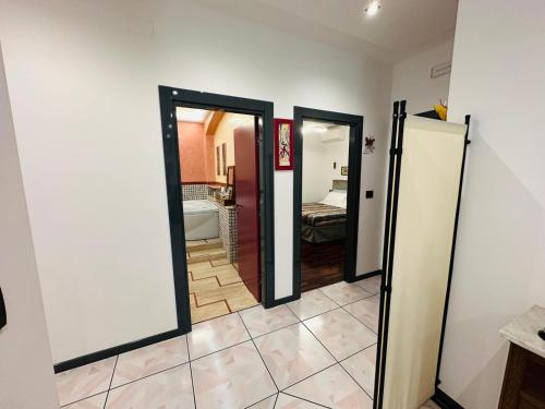 a hallway with three doors and a room with a bed at Villa Alba in Petacciato