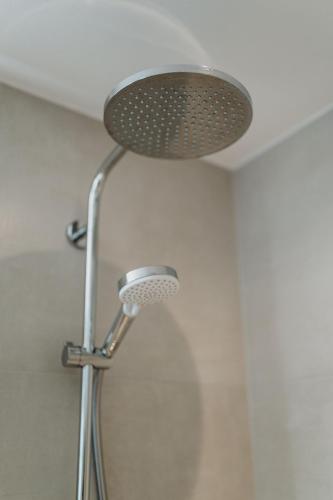 a shower with a shower head in a bathroom at Spreewaldhaus Am Landgut Der Stall in Markische Heide