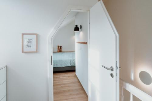 a hallway with a white door leading to a bedroom at Spreewaldhaus Am Landgut Der Stall in Markische Heide