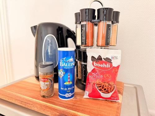 a counter with a coffee pot and some food at l'Escapade de Schiltigheim - Cozy & Bright in Schiltigheim