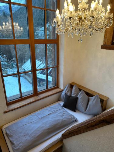 a bed in a room with a large window at Panoramasuite in Flattach