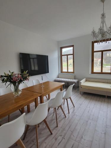 a living room with a wooden table and chairs at Lilienstein in Königstein an der Elbe