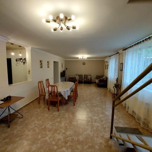 a living room with a table and chairs and a couch at Komfort in Aghk'ilisa