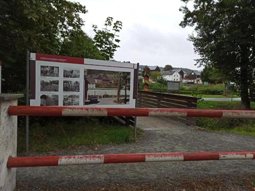 a gate with a sign in front of a building at Gästehaus Siebert in Bad Brambach