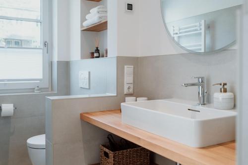 a bathroom with a white sink and a mirror at Spreewaldhaus Am Landgut Das Haupthaus in Markische Heide