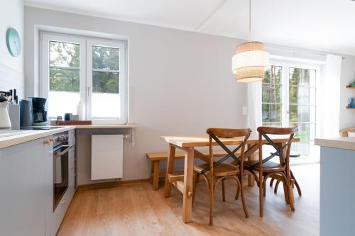 a kitchen with a wooden table and chairs at Spreewaldhaus Am Landgut Das Haupthaus in Markische Heide