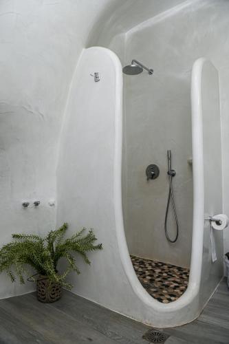 a bathroom with a shower with a large mirror at Vinas Place City Center in Fira
