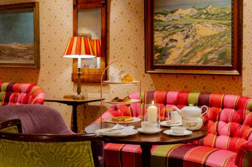 a room with two chairs and a table with teaisers at Hotel Stadt Hamburg in Westerland (Sylt)
