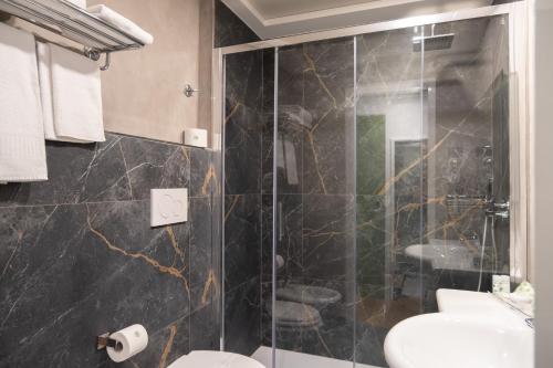 a bathroom with a shower and a toilet at Hotel Dei Congressi in Rome