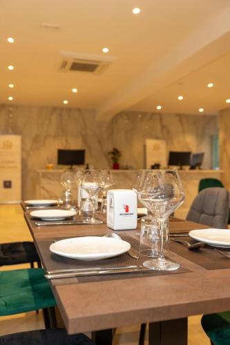 a wooden table with glasses and plates on it at Lh HOTELS in Milan