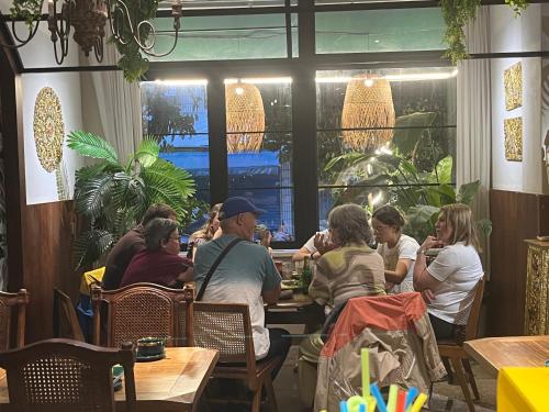 a group of people sitting at a table in a restaurant at Yangshuo Lisa Boutique Hotel in Yangshuo