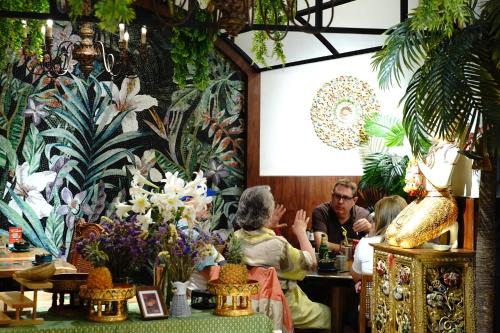 a group of people sitting in a room with flowers at Yangshuo Lisa Boutique Hotel in Yangshuo