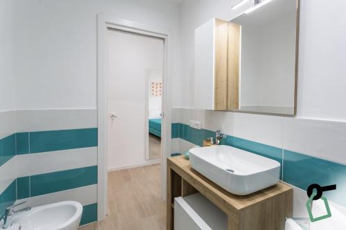 a bathroom with a sink and a mirror at HOTIDAY Room Collection - Byò Home in Sorrento