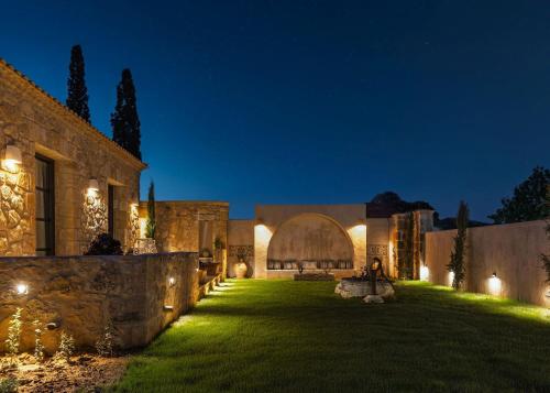 an estate at night with lights on the lawn at Le tresor de Marie - Charming Traditional Retreat, by ZanteWize in Gaïtánion