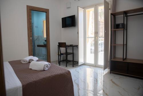 a hotel room with a bed with towels on it at La Dolce Vita rooms & suite in Agrigento