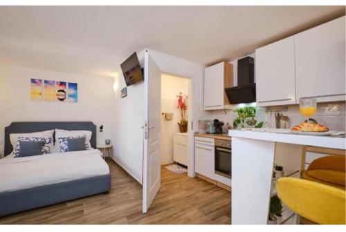 a small bedroom with a bed and a kitchen at ILOVIK FLOWER in Ilovik