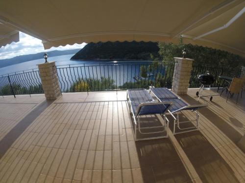a deck with a bench and a view of the water at Poli Home in Stavros