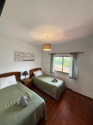 a bedroom with two beds and a window at Dona Ana Beach - Dream Flat in Lagos