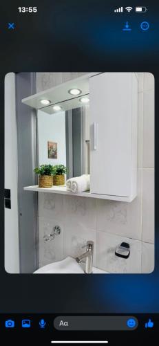 a bathroom with a sink and a mirror at STYILEL apartment MIlos 2 in Triovasálos