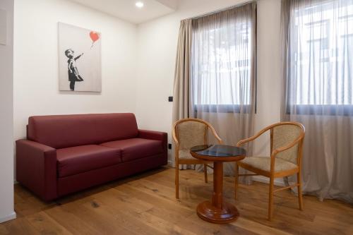 a living room with a couch and a table and chairs at Hotel Dei Congressi in Rome