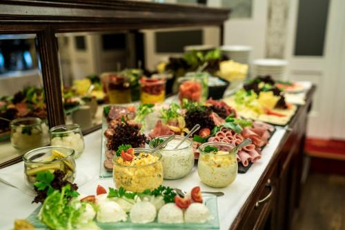 a buffet with many plates of food on a table at Luxury Home / 2-Raum-Apartment an der Frauenkirche in Dresden