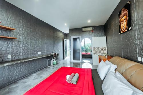 a living room with a couch and a red rug at Margarita Surf Hostel Canggu in Canggu