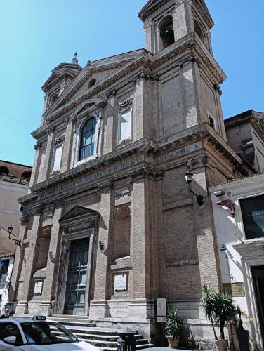 a building with a clock tower on top of it at Sweet Luxury Rooms in Rome