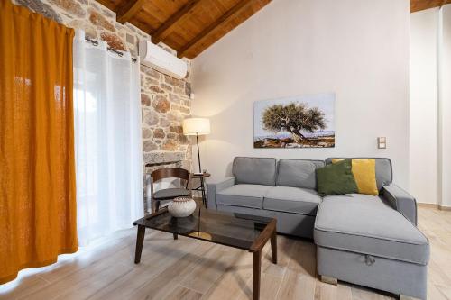 a living room with a couch and a table at Elevi in Tiros