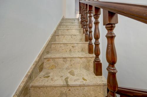 a set of stairs with wooden railings and a stair case at CARO Boutique Guest House in San Ġwann