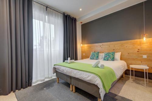 a bedroom with a large bed and a large window at CARO Boutique Guest House in San Ġwann