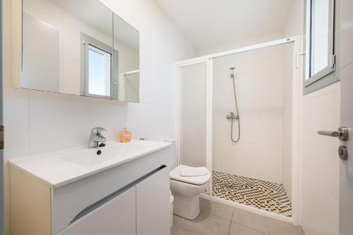 ein weißes Badezimmer mit Toilette und Dusche in der Unterkunft Borges in Son Serra de Marina