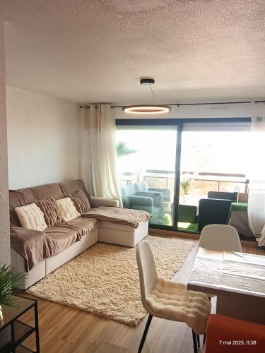 un salon avec un canapé, une table et des chaises dans l'établissement Studio à Valras, à Valras-Plage